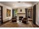 Cozy living room with fireplace, comfortable chairs, and natural light at 1450 Rancho Cir, Las Vegas, NV 89107