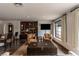 Inviting living room featuring leather chairs, a large bookshelf and a trunk style coffee table at 1450 Rancho Cir, Las Vegas, NV 89107