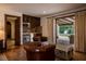 Spacious living room adjacent to outdoor patio area with comfortable seating, wooden cabinetry, and stainless steel appliances at 1450 Rancho Cir, Las Vegas, NV 89107