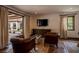 View of a beautifully decorated living room with leather chairs and access to the patio at 1450 Rancho Cir, Las Vegas, NV 89107