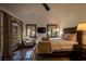 A cozy main bedroom featuring tiled floors, a chair, and a queen-sized bed in a naturally lit space at 1450 Rancho Cir, Las Vegas, NV 89107