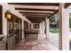 Covered outdoor patio with dining area featuring wood beams and stone flooring, perfect for entertaining at 1450 Rancho Cir, Las Vegas, NV 89107
