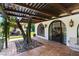 Charming covered patio with unique architectural details, arched windows, stone flooring, and a tranquil outdoor space at 1450 Rancho Cir, Las Vegas, NV 89107