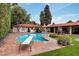Sparkling pool with a diving board surrounded by lush landscaping and a decorative fountain at 1450 Rancho Cir, Las Vegas, NV 89107