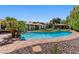 Stunning backyard with a large pool, mature landscaping, and a charming outdoor structure, perfect for entertaining at 1450 Rancho Cir, Las Vegas, NV 89107