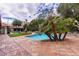 Inviting pool with stone surround, framed by mature palm trees, creating a private oasis at 1450 Rancho Cir, Las Vegas, NV 89107