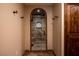 This primary bathroom includes a walk-in shower with travertine surround and an arch entryway at 1450 Rancho Cir, Las Vegas, NV 89107