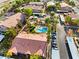 Aerial view featuring a large community pool, mature trees, carports, and multi-story buildings at 5751 Hacienda Ave # 135, Las Vegas, NV 89122