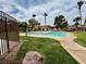 Resort-style community pool surrounded by palm trees and lush green space at 5751 Hacienda Ave # 135, Las Vegas, NV 89122