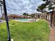 Well-maintained community pool and grassy areas with palm trees at 5751 Hacienda Ave # 135, Las Vegas, NV 89122