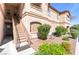 Apartment building exterior with landscaping, a staircase, and stone accents at 5751 Hacienda Ave # 135, Las Vegas, NV 89122