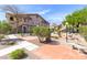 Beautiful condo community with walking paths, mature trees, green bushes and community sitting areas at 5751 Hacienda Ave # 135, Las Vegas, NV 89122