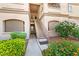 Exterior view of building entrance, stairway, and colorful flowerbeds at 5751 Hacienda Ave # 135, Las Vegas, NV 89122
