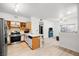 Open kitchen with a breakfast bar, stainless appliances, and tile backsplash detailing at 5751 Hacienda Ave # 135, Las Vegas, NV 89122