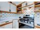 Bright kitchen with a stainless steel gas range, tile backsplash, and ample storage at 5751 Hacienda Ave # 135, Las Vegas, NV 89122
