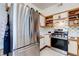 Well-lit kitchen with a stainless steel fridge, modern stove, and custom tile backsplash at 5751 Hacienda Ave # 135, Las Vegas, NV 89122