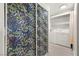 Functional laundry area with modern appliances and stylish floral print sliding doors at 5751 Hacienda Ave # 135, Las Vegas, NV 89122