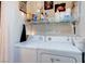 Efficient laundry room with a washer, a dryer, and shelving for storage at 5751 Hacienda Ave # 135, Las Vegas, NV 89122