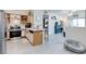 Open living space showcasing the kitchen with white cabinets, stainless appliances, breakfast bar, and the spacious living area at 5751 Hacienda Ave # 135, Las Vegas, NV 89122