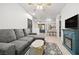 Inviting living room featuring a gray sectional sofa, fireplace, and open view to kitchen at 5751 Hacienda Ave # 135, Las Vegas, NV 89122