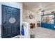 Inviting entry hall with a dark door, coat rack, and a peek into a well-decorated living space with a blue display case at 5751 Hacienda Ave # 135, Las Vegas, NV 89122