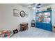 Cozy living space with a blue display case, rattan table with chairs, and dog-themed decor at 5751 Hacienda Ave # 135, Las Vegas, NV 89122