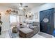 Comfortable living room featuring a gray couch, sliding glass door, and unique decor creating a welcoming atmosphere at 5751 Hacienda Ave # 135, Las Vegas, NV 89122