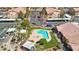 Aerial view of community pool and spa surrounded by lush landscaping, multiple seating areas, and manicured lawn at 5751 Hacienda Ave # 135, Las Vegas, NV 89122