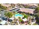 Community pool area with palm trees, cabanas, a pool, and a clubhouse at 5751 Hacienda Ave # 135, Las Vegas, NV 89122