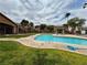 Community pool area features a clean pool, green grass and access to condos in the community at 5751 Hacienda Ave # 135, Las Vegas, NV 89122
