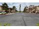 Community street featuring well-maintained landscaping, mature trees, and residential buildings at 5751 Hacienda Ave # 135, Las Vegas, NV 89122