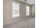 Neutral bedroom with grey carpet, bright windows, and white trim at 5913 Flowering Hill Ct, Las Vegas, NV 89131