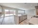 Bright, open-concept kitchen with large island, stainless steel appliances, and access to outdoor space at 5913 Flowering Hill Ct, Las Vegas, NV 89131