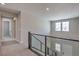Upstairs hallway with window and railing overlooking stairs at 5913 Flowering Hill Ct, Las Vegas, NV 89131