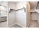 Walk-in closet with ample shelving and carpeting, conveniently located next to the bathroom at 5913 Flowering Hill Ct, Las Vegas, NV 89131
