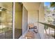Balcony with rocking chair, overlooks exterior foliage and structure providing a peaceful retreat at 725 N Royal Crest Cir # 214, Las Vegas, NV 89169