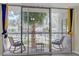 Balcony with seating overlooking lush greenery, a pool, and palm trees, providing a serene outdoor space at 725 N Royal Crest Cir # 214, Las Vegas, NV 89169
