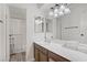 Bright bathroom featuring modern vanity, large mirror and a shower/tub combo at 725 N Royal Crest Cir # 214, Las Vegas, NV 89169