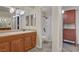 Bathroom with stylish cabinets, framed mirrors, and shower-tub combo, providing a functional space at 725 N Royal Crest Cir # 214, Las Vegas, NV 89169