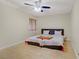 Bright bedroom featuring a ceiling fan, wood-look floors, and a comfortable bed with stylish quilt at 725 N Royal Crest Cir # 214, Las Vegas, NV 89169