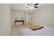 Well-lit bedroom with wood floors, a ceiling fan, and a desk, offering a clean and inviting space at 725 N Royal Crest Cir # 214, Las Vegas, NV 89169