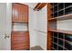 Organized walk-in closet featuring custom wood shelving and cabinets for optimal storage at 725 N Royal Crest Cir # 214, Las Vegas, NV 89169