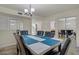 Well-lit dining area offering an elegant dining set with mirrored sliding door at 725 N Royal Crest Cir # 214, Las Vegas, NV 89169