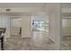 Bright living room featuring sliding glass doors to balcony and neutral tile flooring at 725 N Royal Crest Cir # 214, Las Vegas, NV 89169