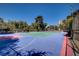 Well-maintained tennis court with a blue and green surface and surrounding greenery at 725 N Royal Crest Cir # 214, Las Vegas, NV 89169