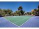 Well-maintained tennis court with a blue and green surface and surrounding greenery at 725 N Royal Crest Cir # 214, Las Vegas, NV 89169