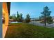 Landscaped backyard featuring a grassy area and fenced-in pool at 7416 Redhead Dr, North Las Vegas, NV 89084