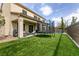 The backyard features a trampoline, patio, and artificial turf lawn at 7416 Redhead Dr, North Las Vegas, NV 89084