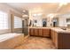 Primary bathroom with dual sink vanity, garden tub and glass enclosed shower at 7416 Redhead Dr, North Las Vegas, NV 89084