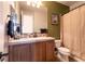 The bathroom features a wood vanity, decorative mirror, and shower with curtain at 7416 Redhead Dr, North Las Vegas, NV 89084